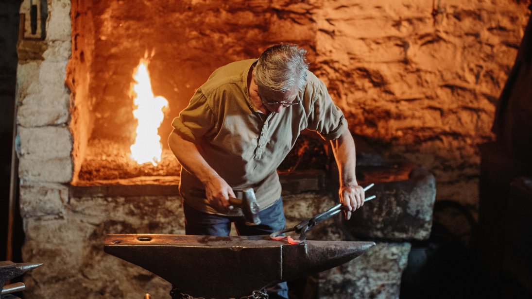 A blacksmith at the Forge in the folk museum 