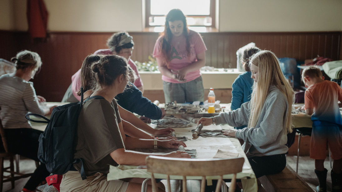 a group of people doing crafts in the folk museum