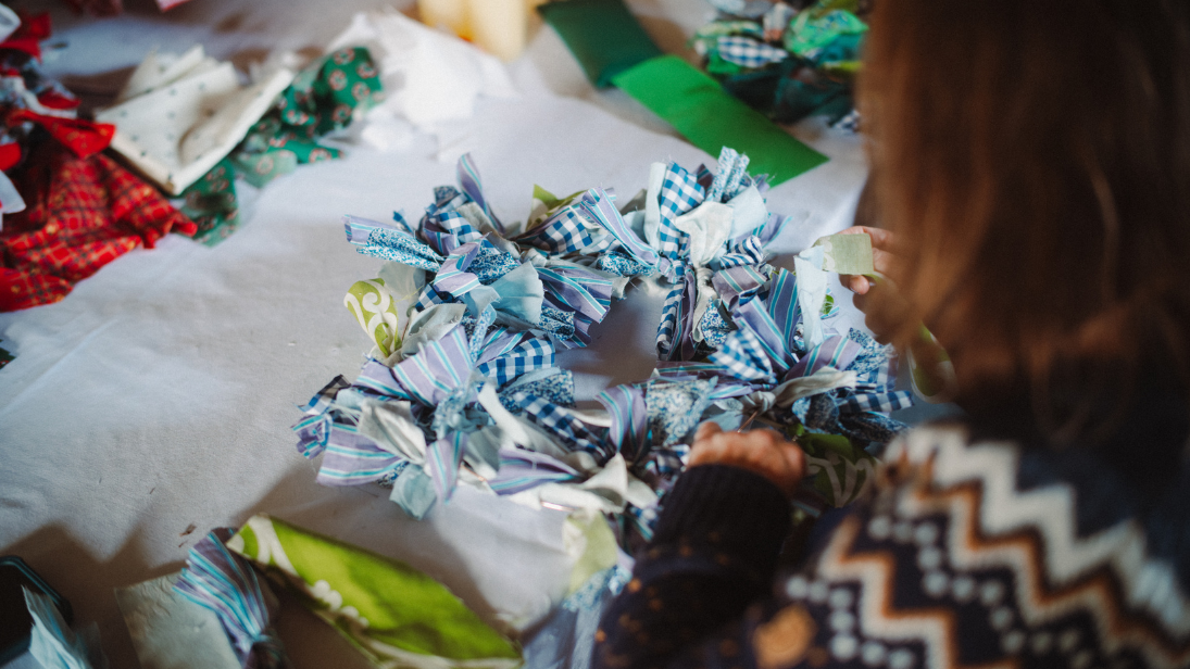 A women making a rag wreath 