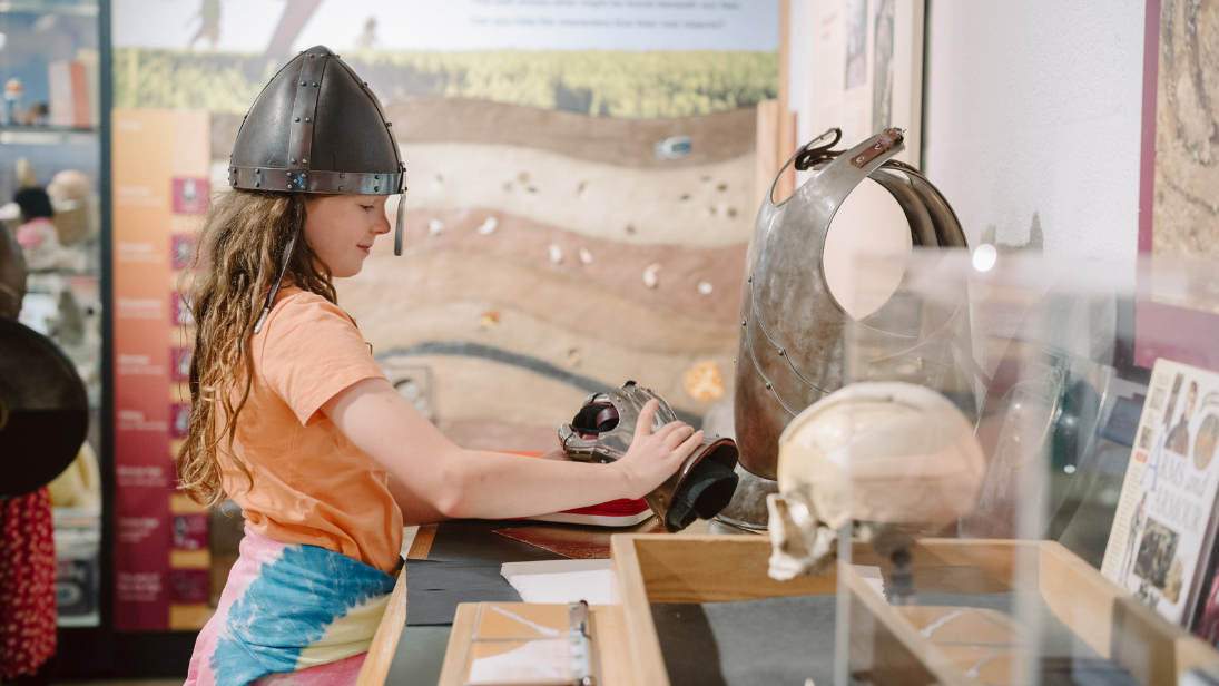 A girl playing with objects in discover history 