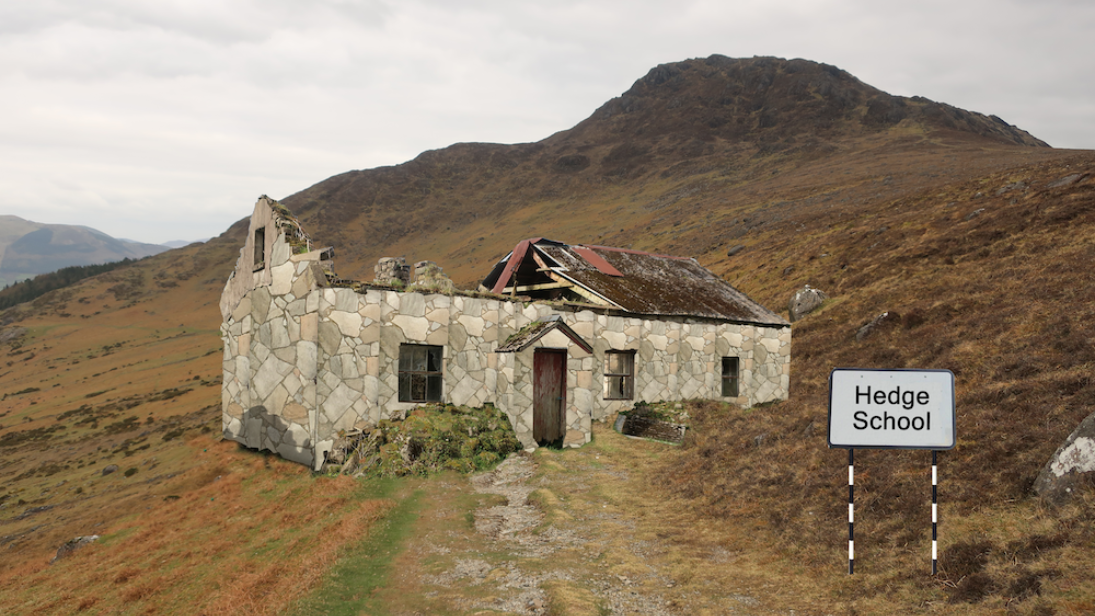 Tom Ó Caollaí image of a small grey house on a mountain