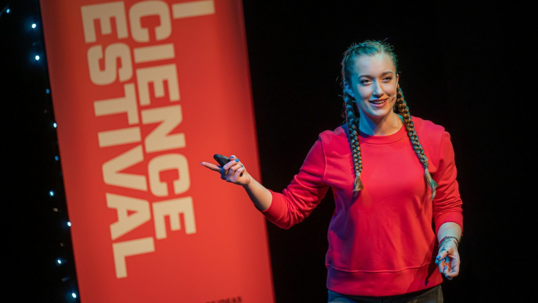 Grace Webb, a woman in a red jumper with plaited hair