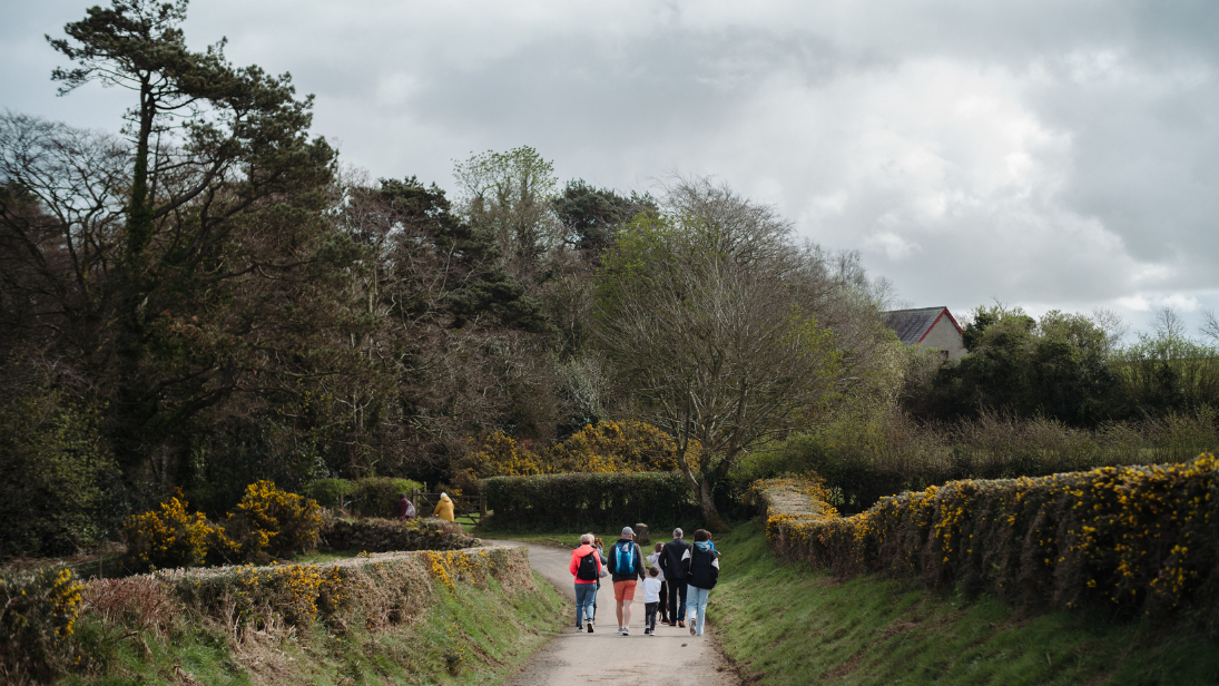 A family walking through the rural area of ulster folk museum