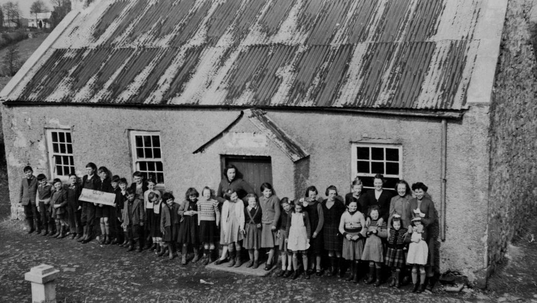 Teachers and pupils standing outside School