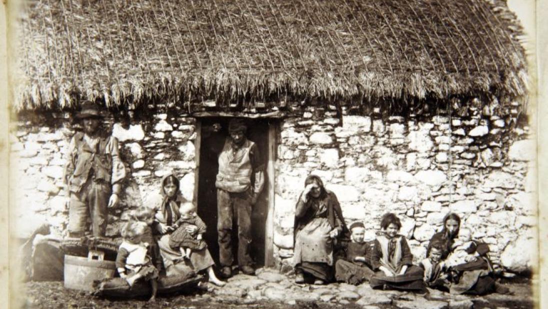 View of Gweedore dwelling with family at the door, black and white photograph