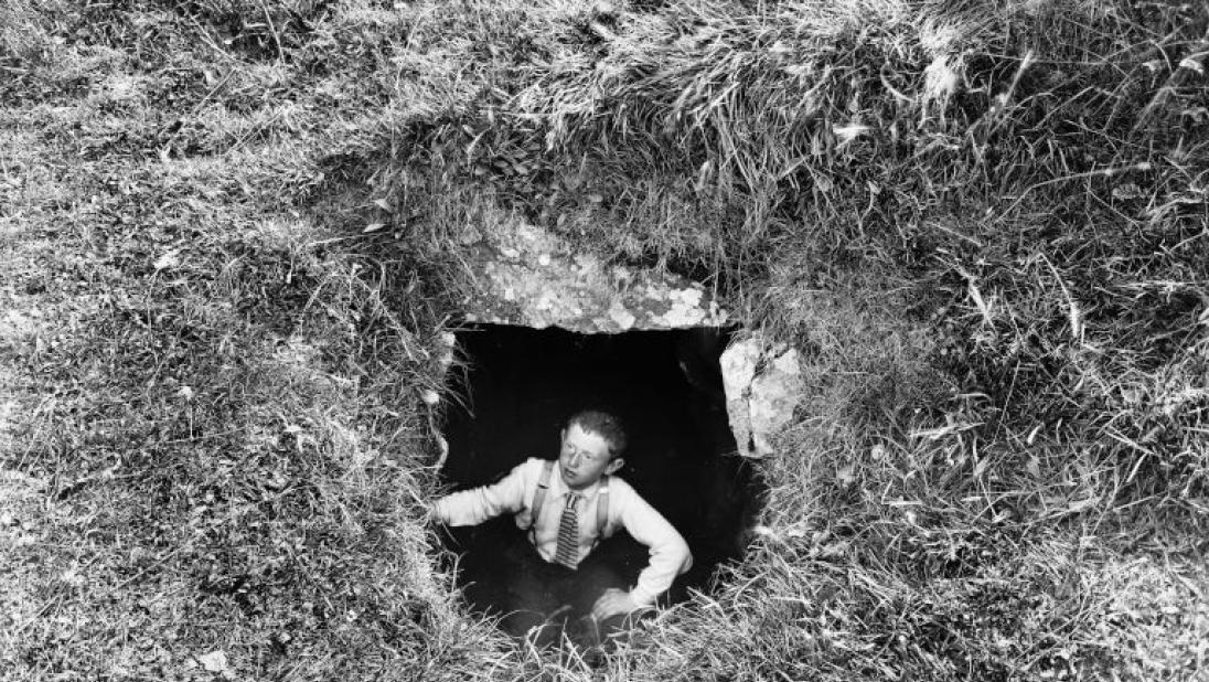 A boy looks out of a souterrain.