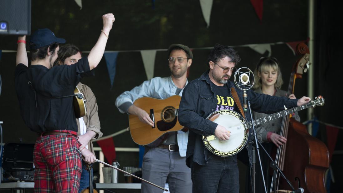 A Bluegrass band enjoying their performance on stage