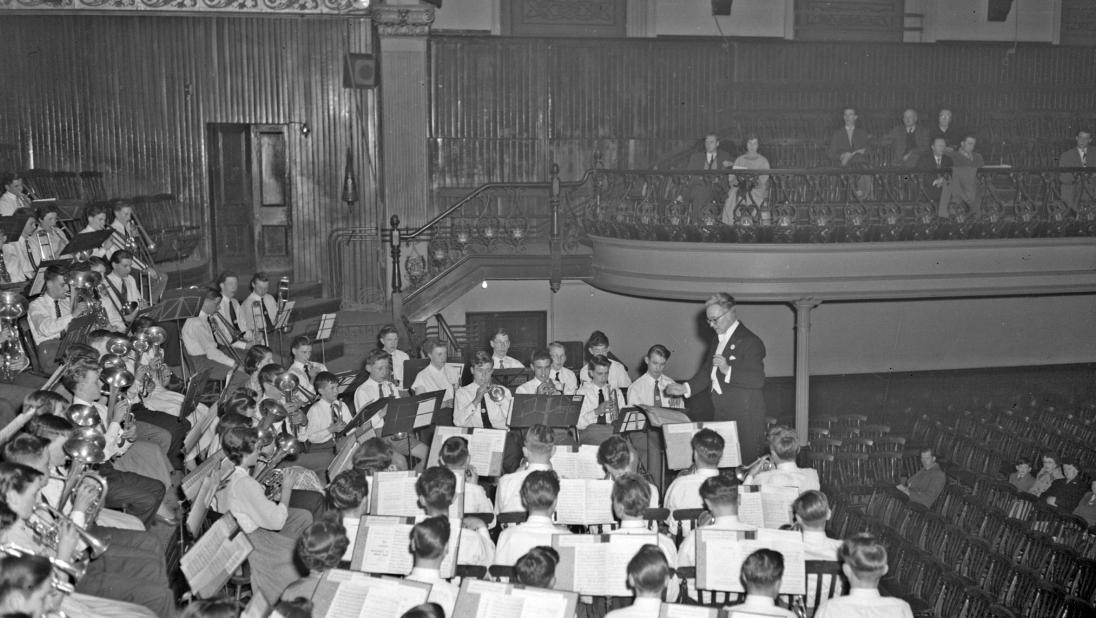 A wide view of a children's orchestra. The image is in black and white.