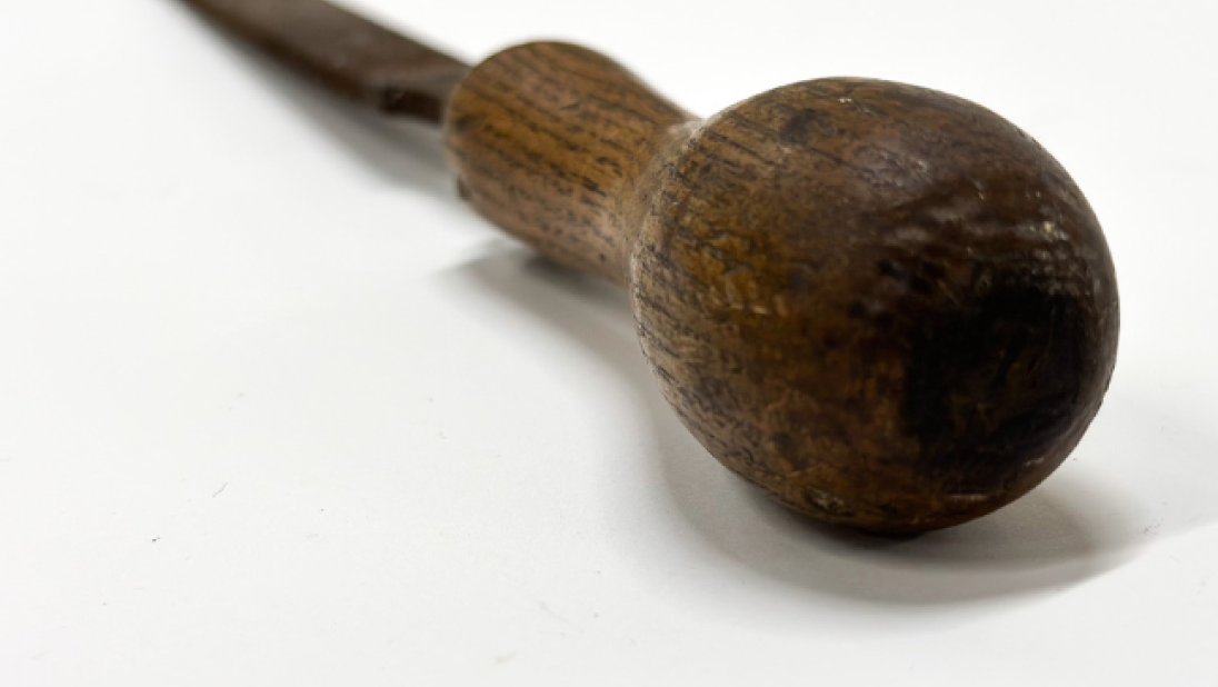 The wooden handle of a carpenter's file.