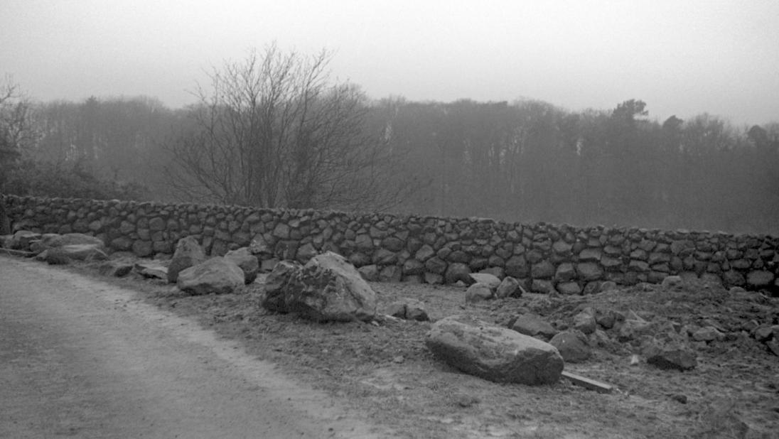 An image of a stone wall stretching into the distance.