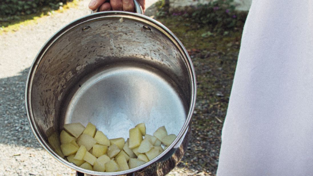 Washed and cut potatoes in a pot outside