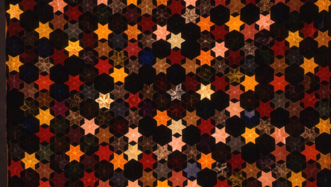 A quilt with star patterns scattered across the whole quilt.