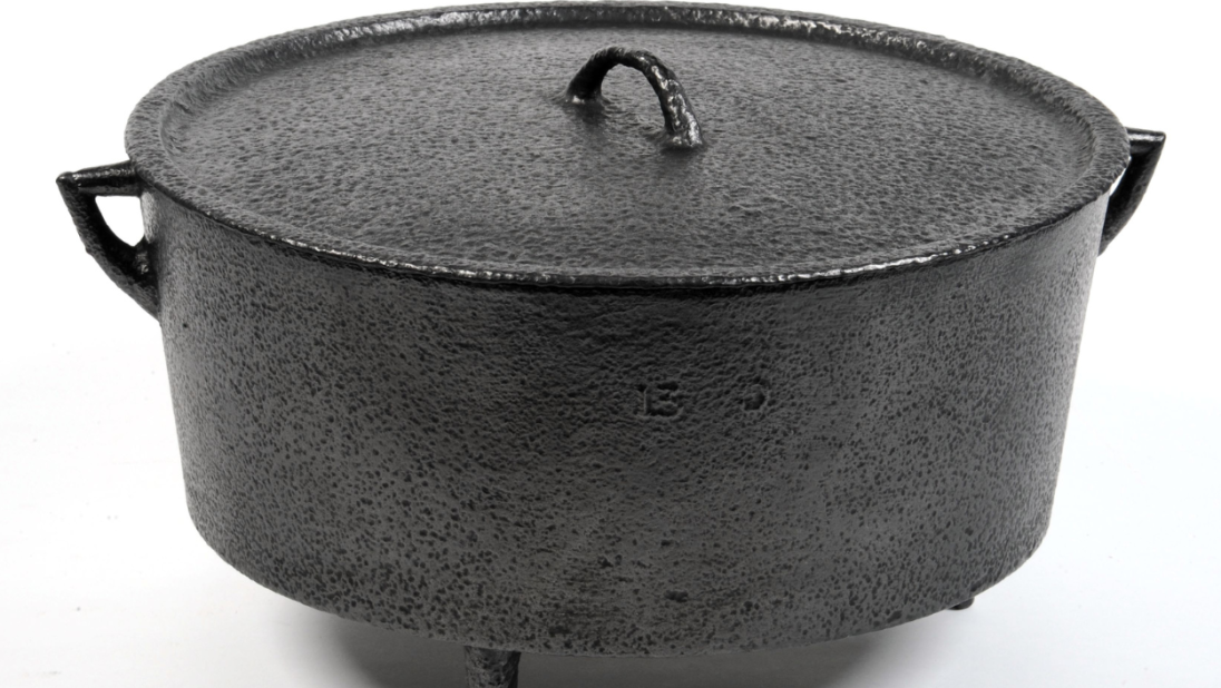 A metal cooking pot with a lid on top.