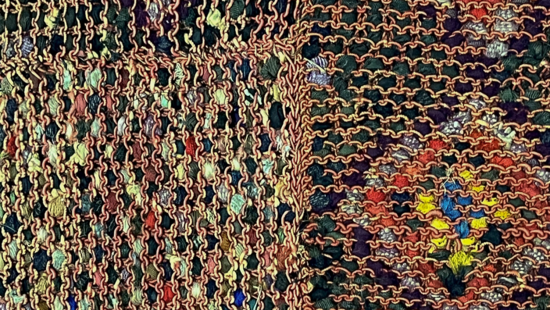 The detail of the back of a rug showing the multicoloured fabric work.
