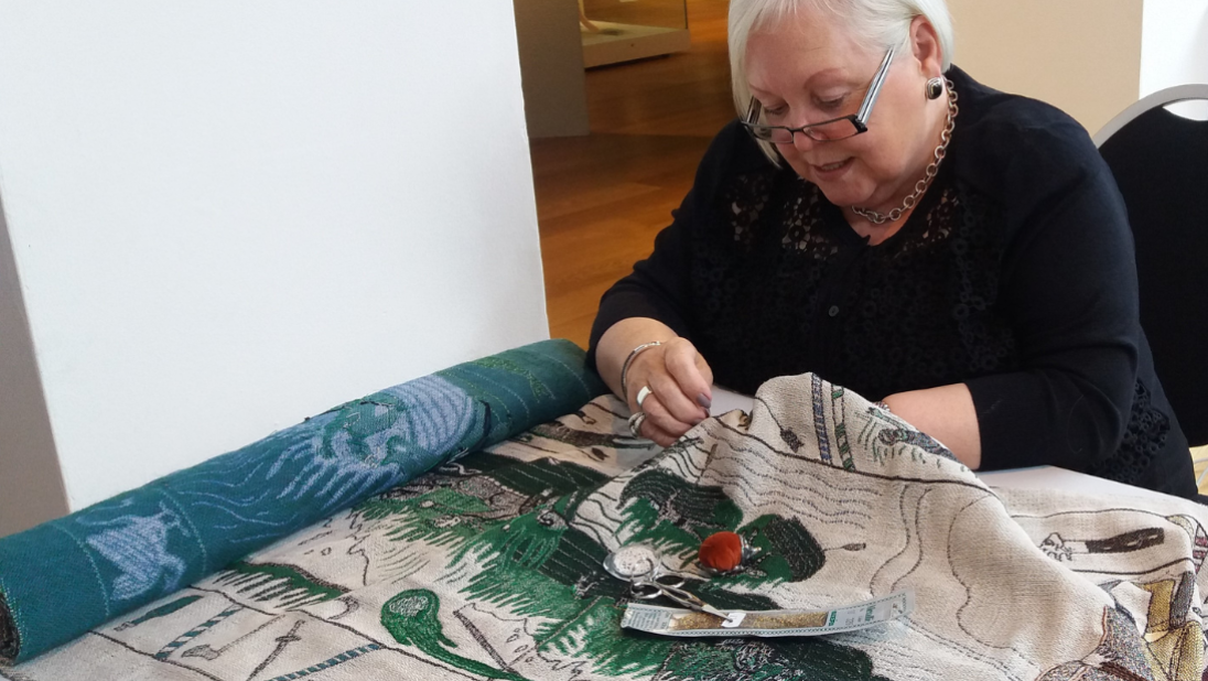 Anne Robinson at work on the tapestry