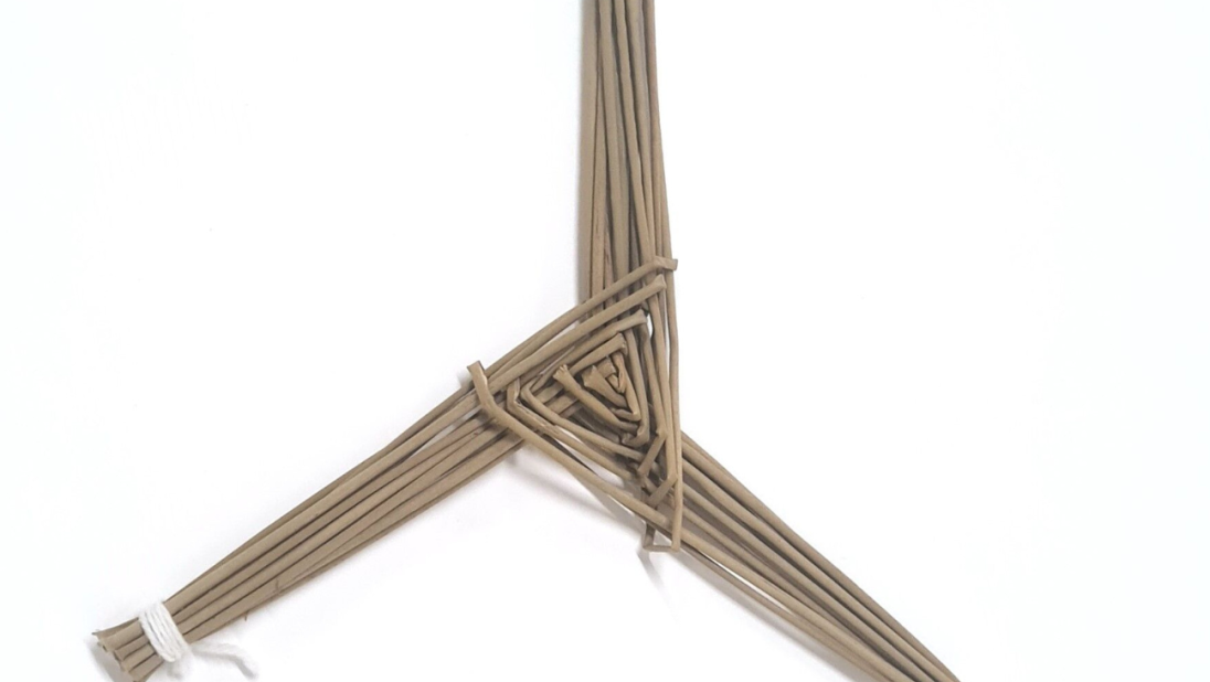 A Saint Brigid's Cross. The cross is a simple three legged cross with three thick legs.
