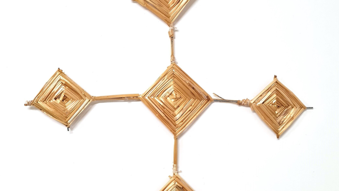 A Saint Brigid's Cross. The cross has a diamond centre with four legs of equal length that end in diamond shapes the same size as the centre diamond.