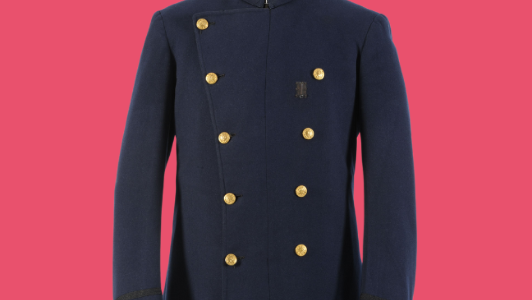 Boston police jacket, navy with gold buttons, on a mannequin on a pink background