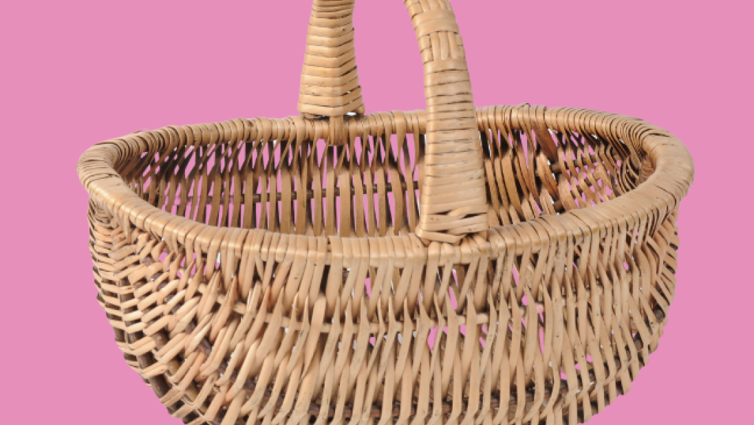 Wicker basket on a pink background