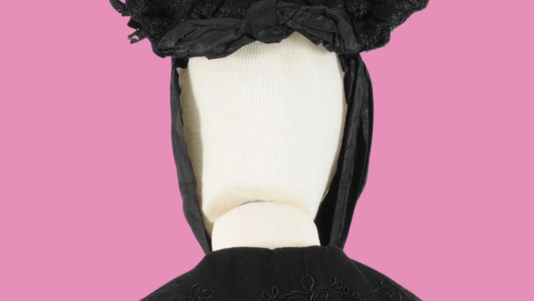 Black hat and cape on a pink background