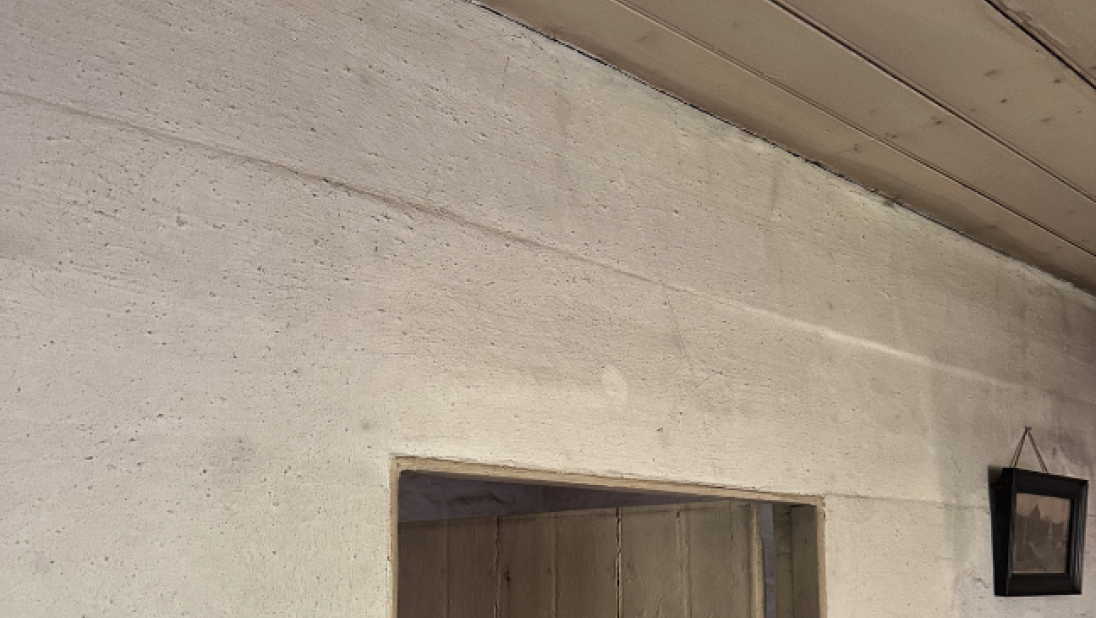 The wall and roof of a room, built out of wood.