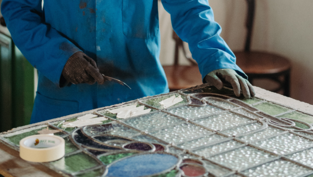 A person doing stained glass making 