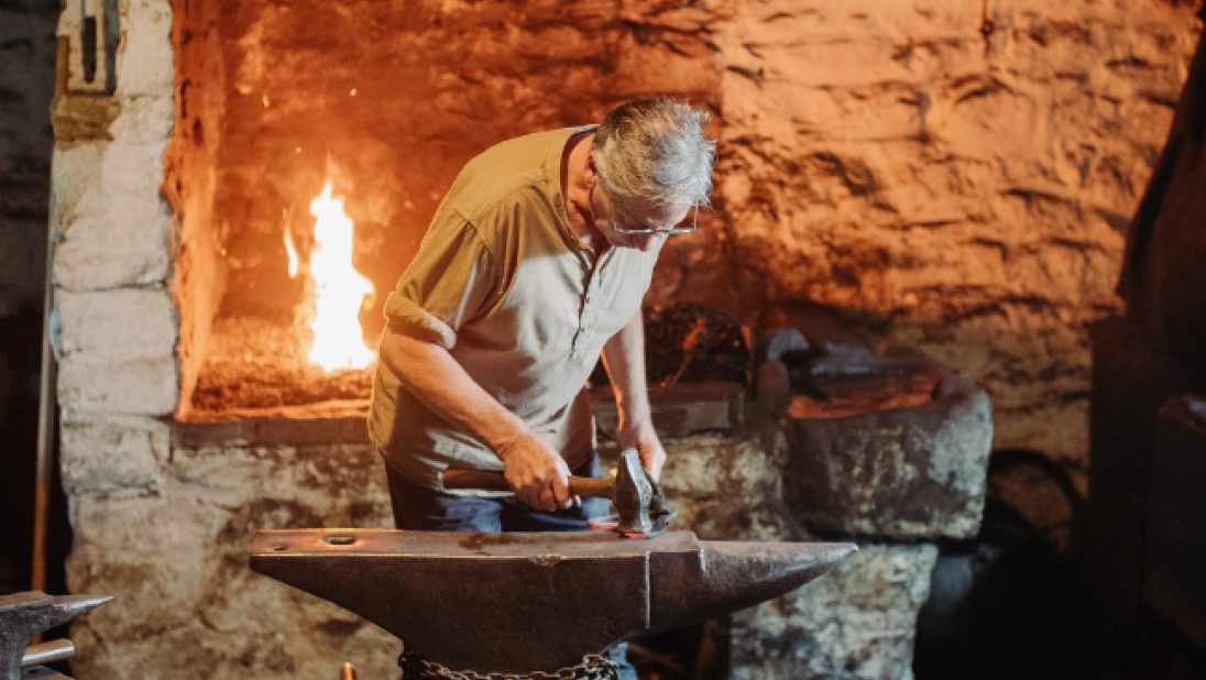 A blacksmith at the Forge in the folk museum 