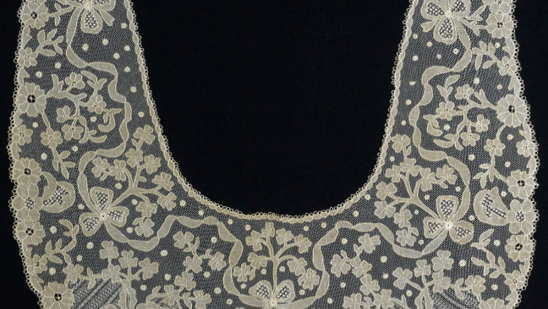 A lace collar with intricate design feature flowers. 