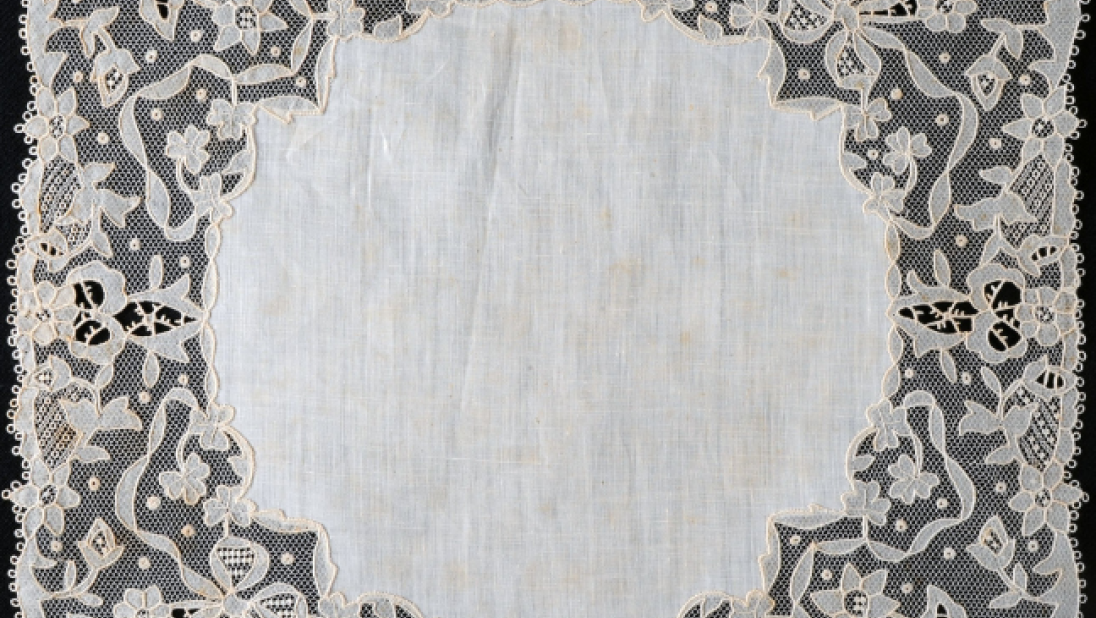 A handkerchief with a large lace border. 