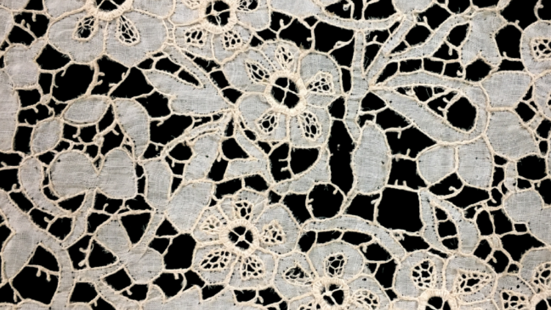 A close up image of Carrickmacross lace, with flower patterns.