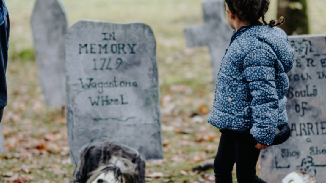 a child looking at  Halloween decorations at the folk park 