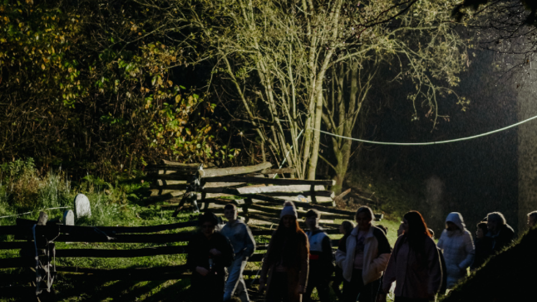 a group walking on a torchlight tour