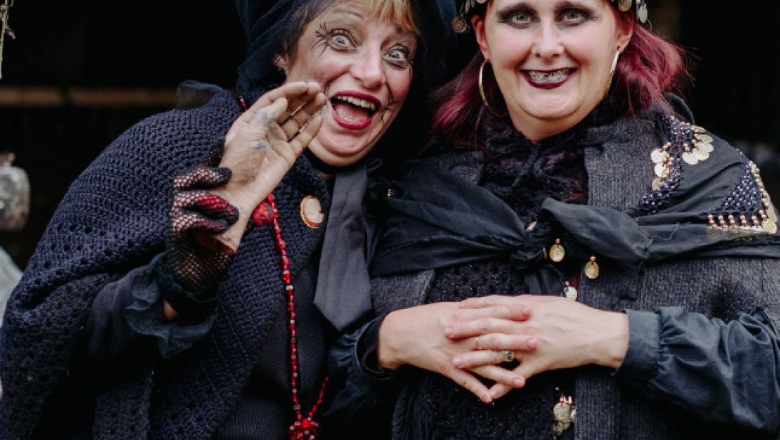 Two women dressed in costume for halloween at the folk park 