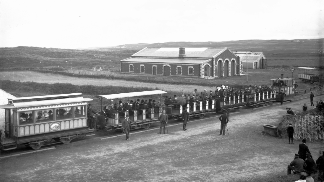 A black and white photograph showing a tram on its line.