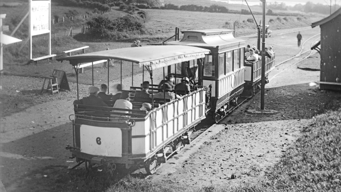 A black and white photograph showing a tram on its line.