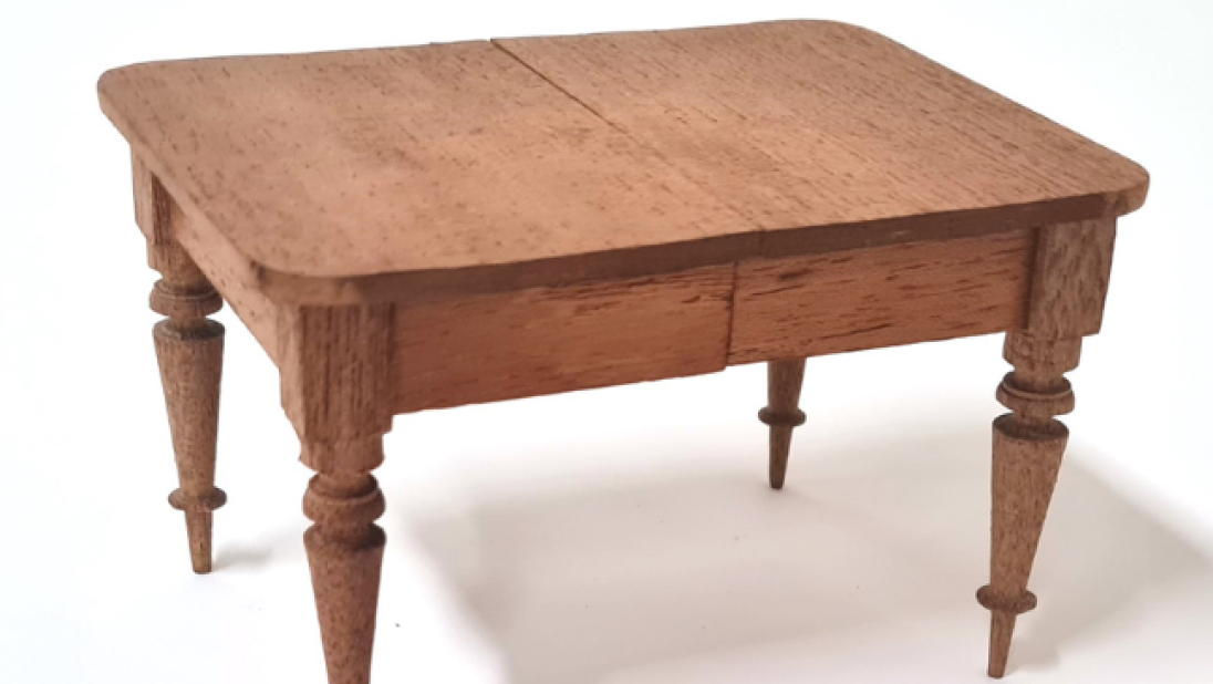 A wooden table for a dolls' house. It is expertly made.