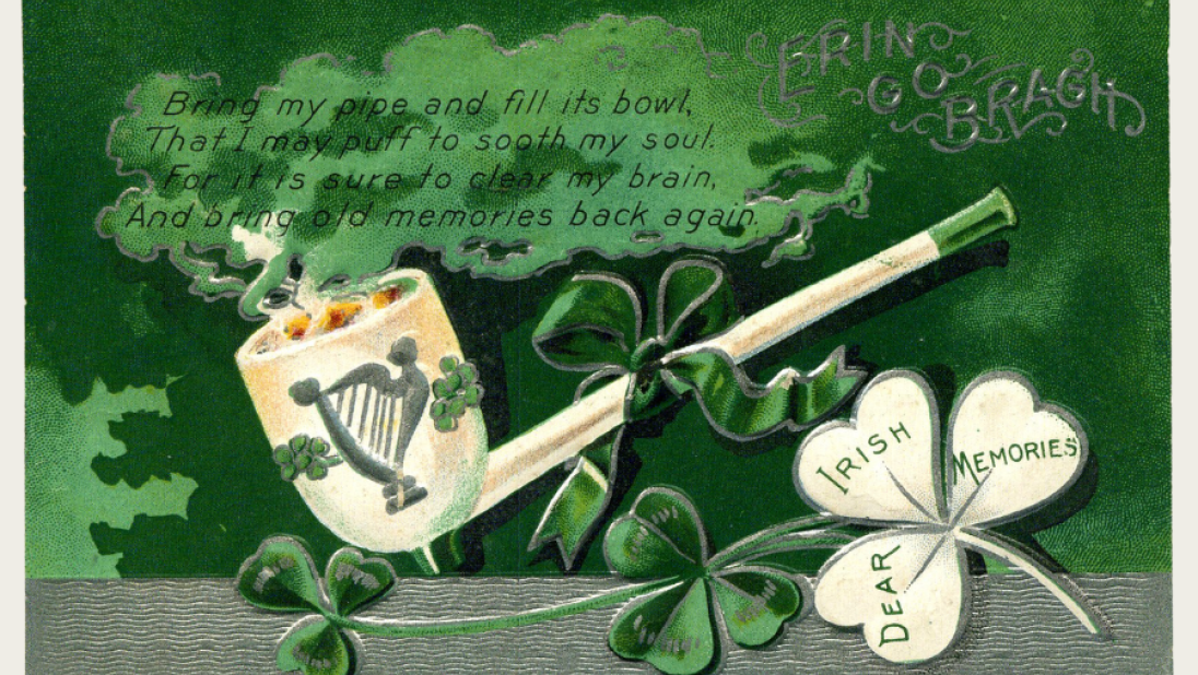 A St Patrick's day postcard with a pipe and clover decoration. 