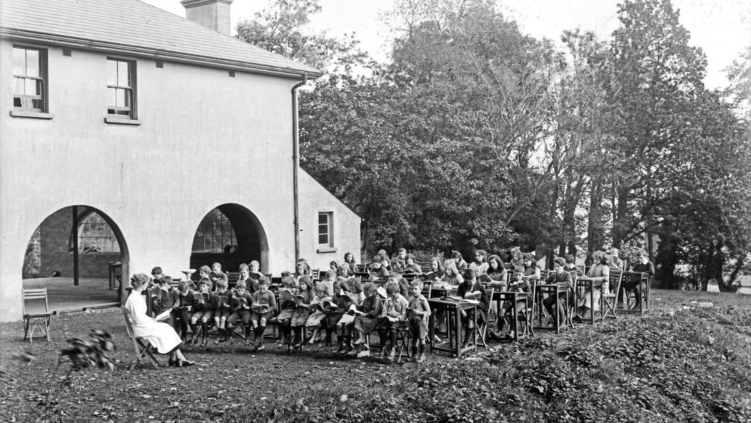 A black and white photograph of an outdoor school.