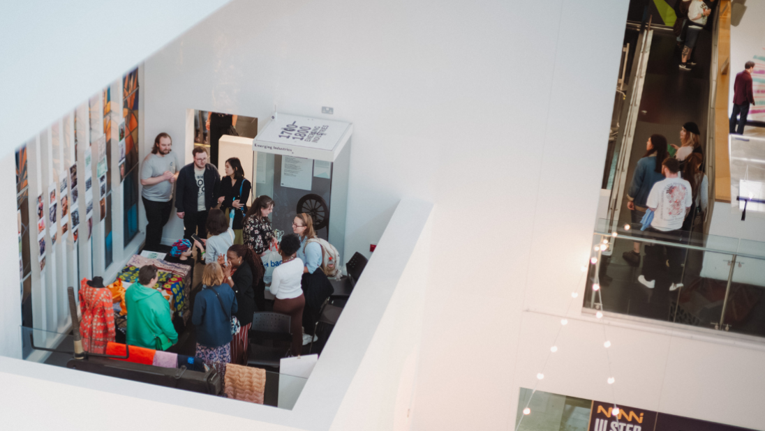 People walking around floor levels of the Ulster Museum. 