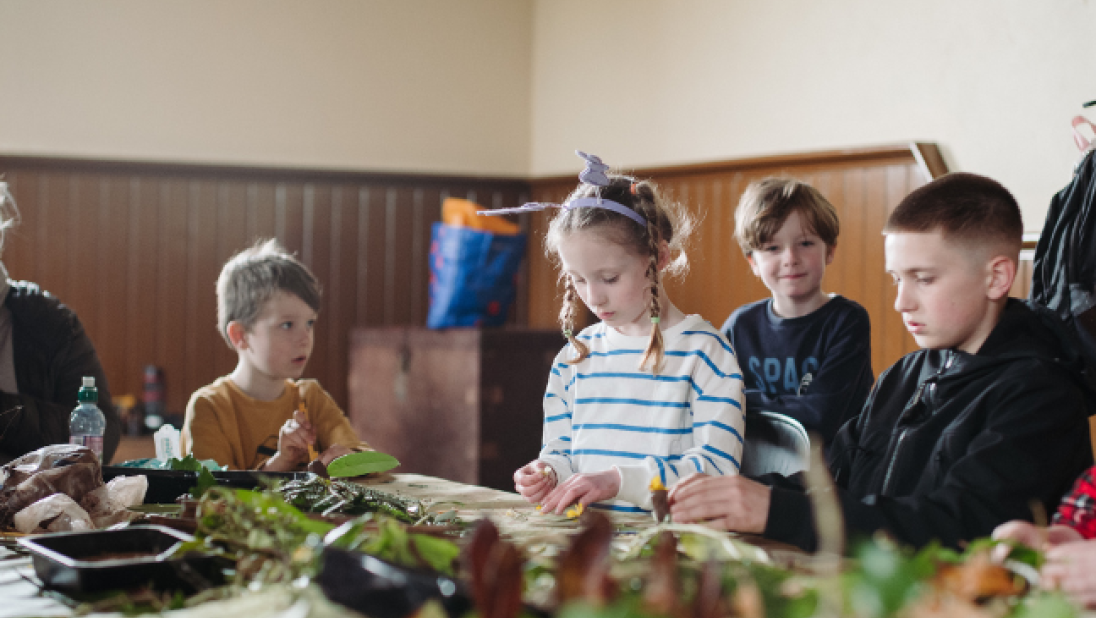 a group of children doing crafts at a table