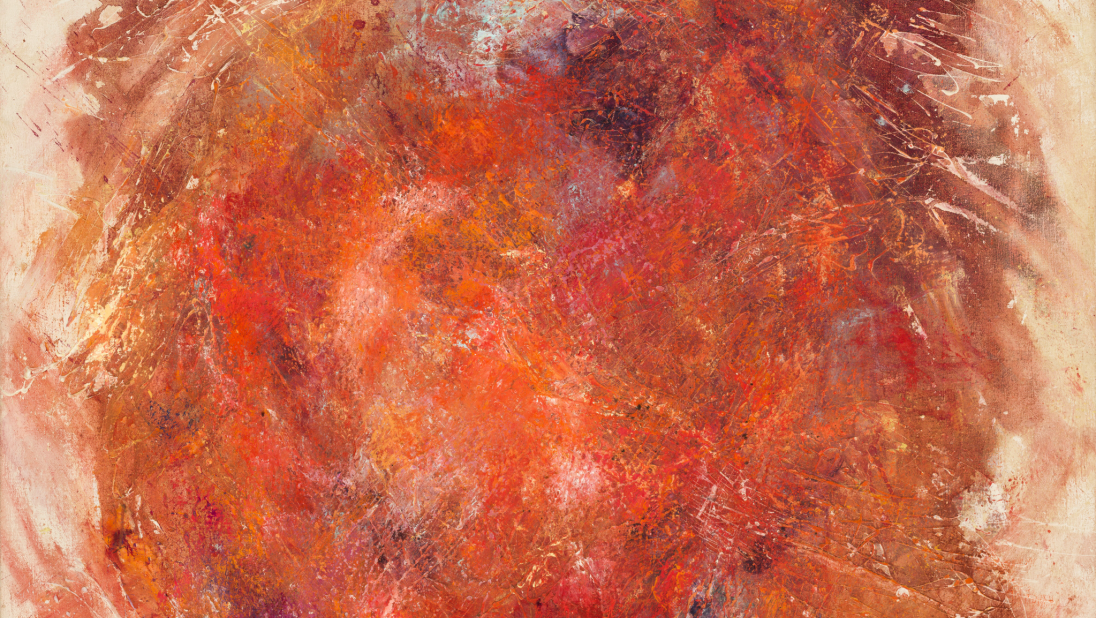 An abstract painting. In a circle, paints of reds and oranges have been brushed and dabbed on, with messy edges. A slight blue can be seem in the top of the loose-circle.