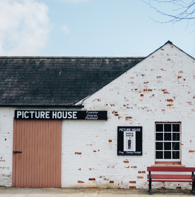 An old picture house, with a Charlie Chaplin poster on a board.