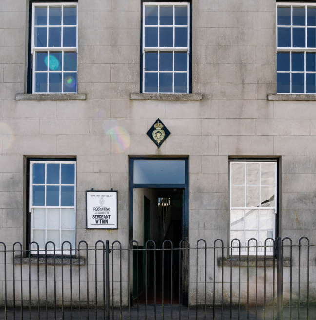 A entrance way with a Royal Irish Constabulary insignia  bove the door.