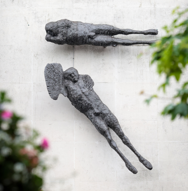 Elisabeth Frink angel sculptures installed on an exterior wall