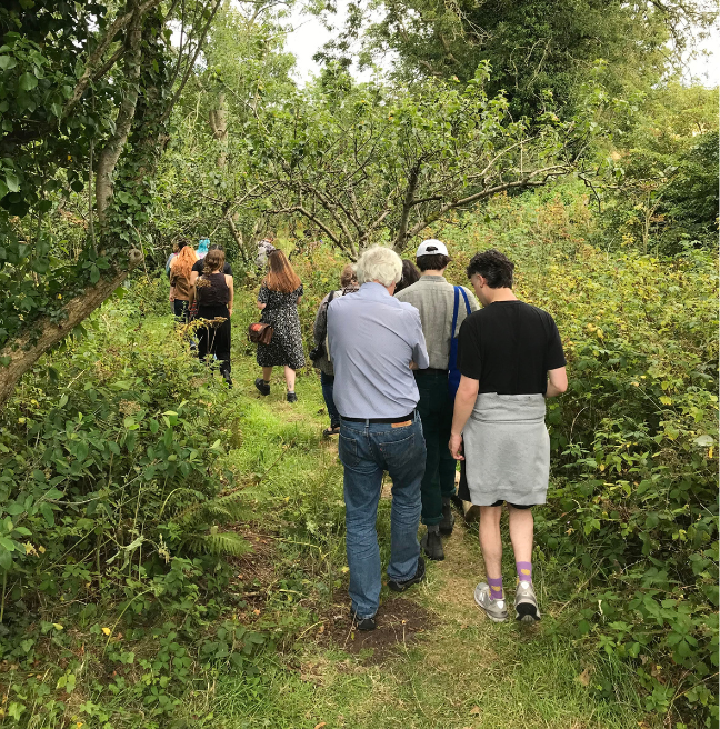 Group of people walking through trees