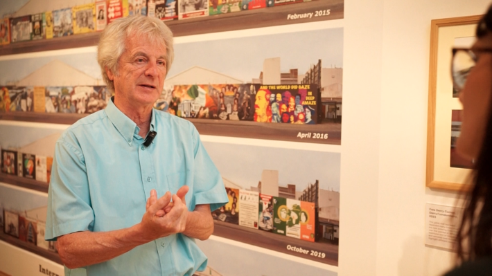 Bill Rolston beside the Belfast wall