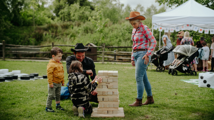 A family playing giant jenga at the ulster american folk park