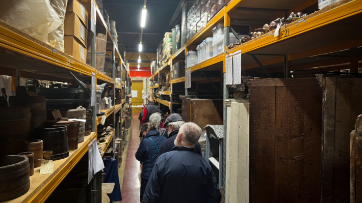 A group of people walking through the Folk Life stores