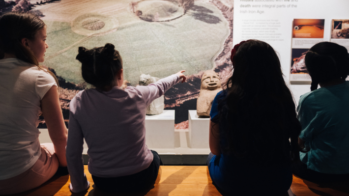 4 children looking at a display in a museum