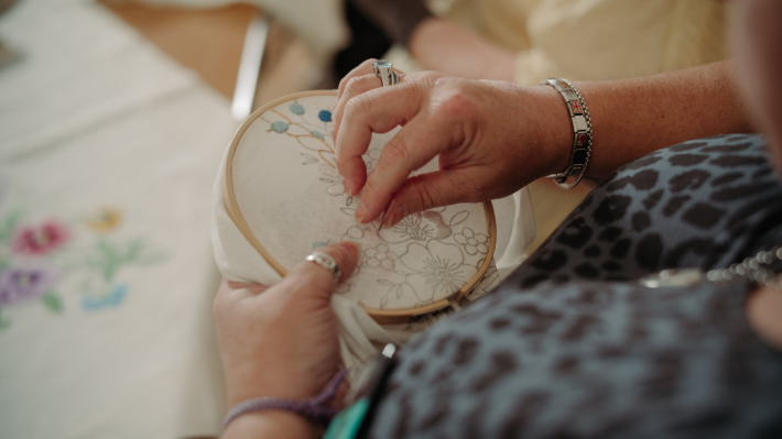 A lady embroidering flowers